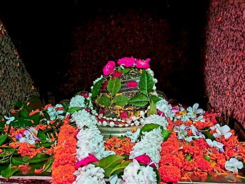 Shri Markandey Rishi ji decorated with 3 Lotus Flowers on the top, many Belpatras & flowers one thin white garland, one thick white garland, one thick marigold garland. 